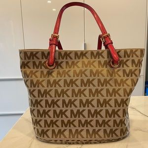Michael Kors “Jet Set” tote Tan with brown lettering gold accents, red straps